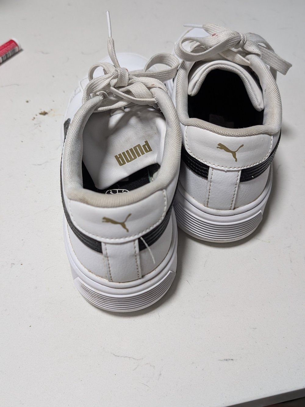 Puma White Sneakers with Black Stripe and Gold Logo